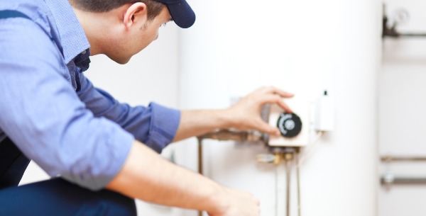 plumber adjusting temp on water heater